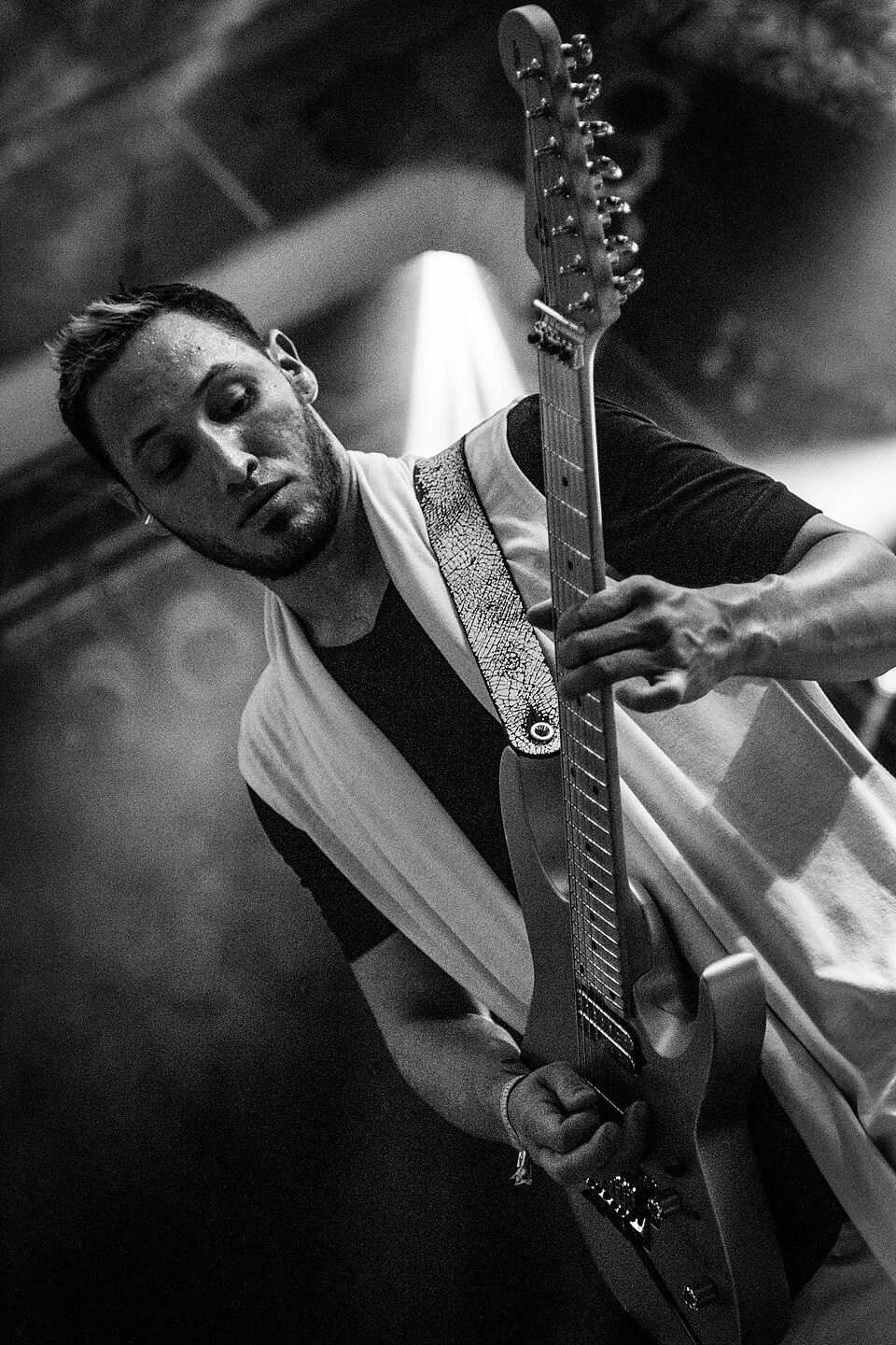 Angel Vivaldi performing on guitar at a festival
