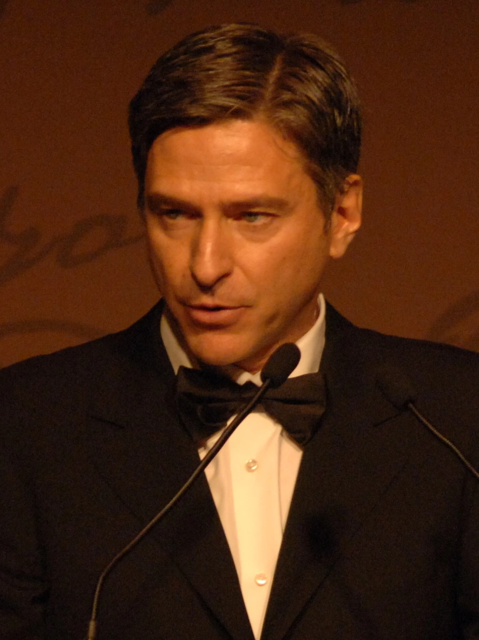 Vin Cipolla speaking at a podium in a tuxedo